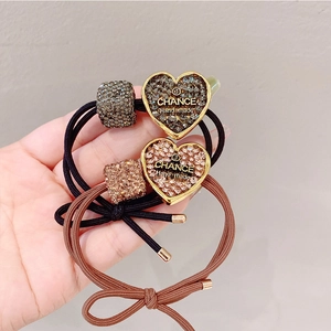 Elastic hair ties set with gold heart charms and sparkling rhinestones for ponytails