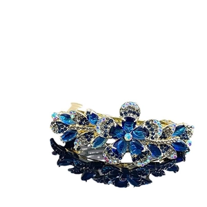 Pince à cheveux élégante avec cristaux bleu foncé et strass sur monture dorée chic
