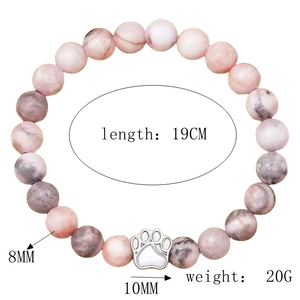 Detail showing 8mm tricolor natural stone beads and 10mm silver animal paw charm on bracelet