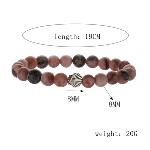 Macro detail of natural stone beaded bracelet with 8mm pink zebra jasper and silver shell