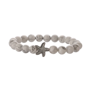 Handmade beaded bracelet with white marble patterns and a silver vintage starfish pendant