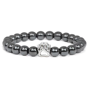 Macro shot of 10mm hematite beads bracelet with a silver dog paw print metal charm