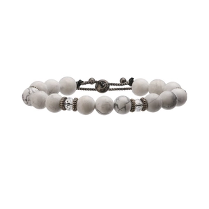 Detailed view of white turquoise beads with antique bronze gears and adjustable black cord