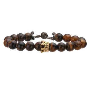 Detailed macro view of natural tiger eye stone beads and golden crown charm on a bracelet
