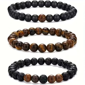 Detail view of 3pcs set featuring tiger eye, lava rock and matte black beaded bracelets