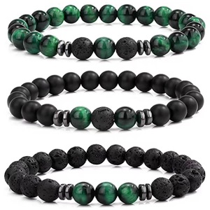Macro detail of beaded bracelets featuring tiger eye, malachite, and black lava stone textures