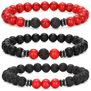 Detail of beaded bracelet set with red marble stone and black lava rock textures