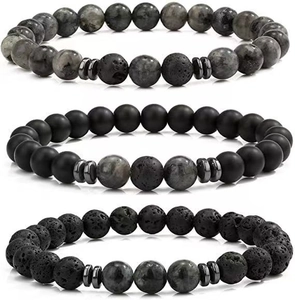 Detail of natural lava rock and matte onyx beaded bracelets with metallic spacers