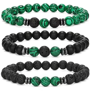 Close-up of three beaded bracelets with malachite, matte black stones and lava rock