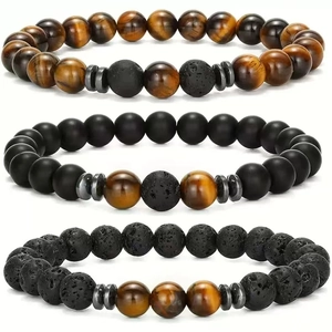 Three beaded bracelets set with tiger eye, volcanic lava stone, and matte black beads