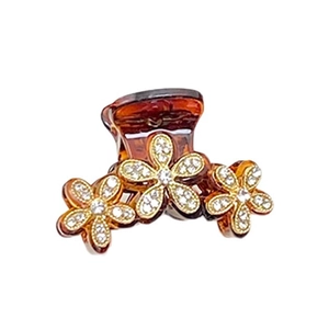 Eleganter bernsteinfarbener Blumen-Haarclip mit Strasssteinen und goldenen Details auf weiß