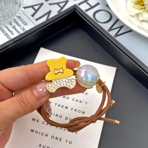 Brown high-elastic hair tie with yellow rhinestone bear charm and iridescent pearl