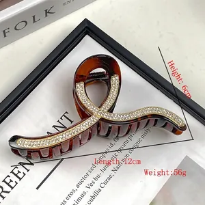 Large geometric claw clip with dark brown tortoiseshell finish and crystal wave pattern