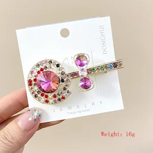 Lolly haarspeld met roze strassteentjes en gouden legering, maat 7x3,5 cm