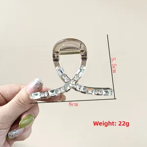 Detail view of the crystal hair claw clip showing 8cm width and 5.5cm height measurements