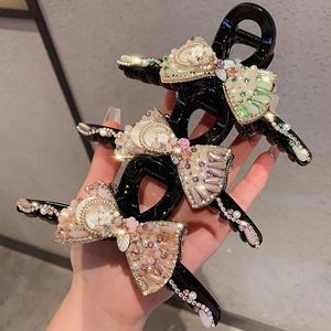 Elegant bow hair claw with rhinestones and pearls in three luxury color variations