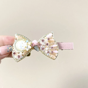 Elegant gold bow hair clip with pink crystals, resin roses and pearls for women