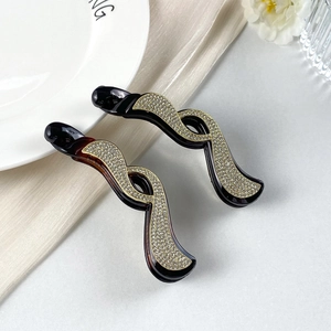 Set di fermagli a banana con strass luccicanti nei colori nero e ambra per coda alta