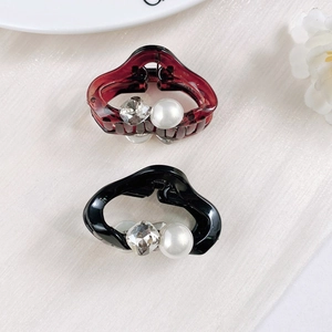 Close-up of mini pearl and crystal hair clips in burgundy and black resin