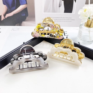 Three elegant hollow cloud-shaped hair claws in floral, cream, and smoke gray colors