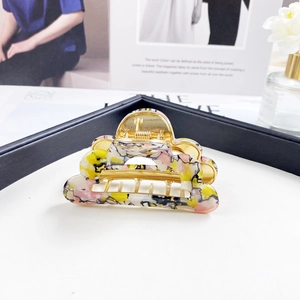 Detailed shot of cloud-shaped acetate hair claw clips with colorful floral patterns