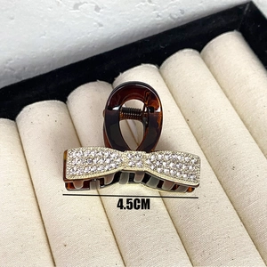 Detail showing 4.5cm width of tortoise shell hair claw clip with crystal rhinestones