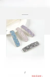 Detailed macro view of four pastel crystal rectangle BB hair clips for girls