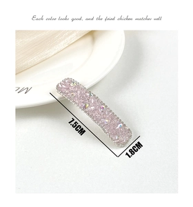 Detailed macro view of a 7.5cm pink crystal hair clip with iridescent rhinestones