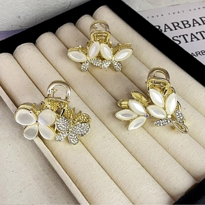 Elegant gold flower hair claws set with white opal and crystals for half-up hairstyles