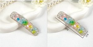 Detail view of a candy-colored crystal hair clip with 8cm length and refined side profile