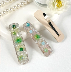 Detailed view of handmade macaron crystal hair clips with sparkling rhinestones and beads