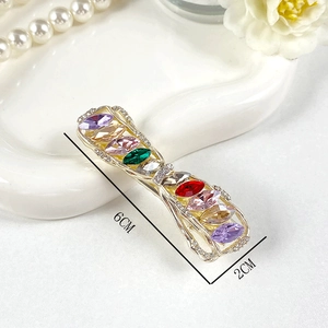 Detail view of crystal butterfly hair clip with 6cm x 2cm dimensions and golden frame