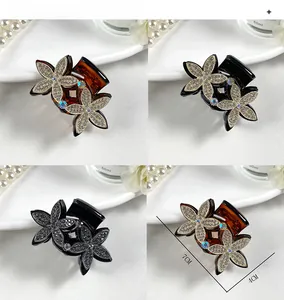 Detailed macro view of 7cm floral hair claw clip with sparkling rhinestones decoration