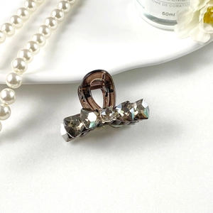 Detail of elegant grey K9 crystal hair clip with polished finish and spring mechanism