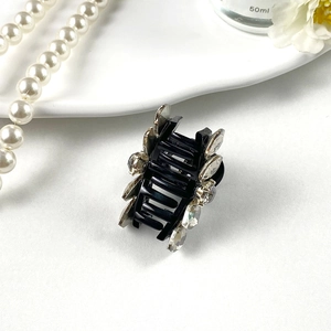 Close-up of black hair claw clip featuring sparkling K9 crystal rhinestones in elegant design