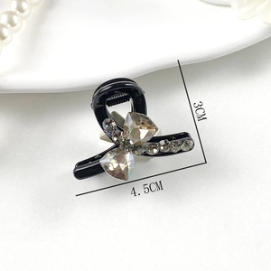 Elegant grey K9 crystal bow hair claw clip in black acrylic finish with dimensions 4.5x3cm