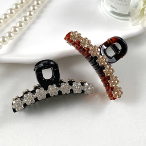 Elegante Haarspangen in Schwarz und Bernstein mit funkelnden Strassblumen für Damen