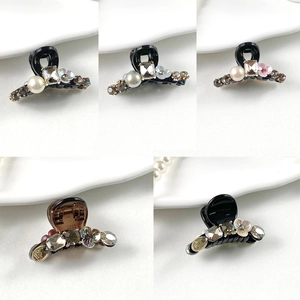 French style small hair claw clips set with pearls and rhinestones on white background