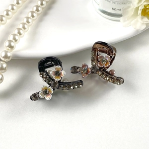 Elegant pearl rhinestone hair clips in black and amber resin with floral details