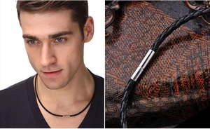 Close-up of black braided leather necklace with silver cylindrical magnetic clasp
