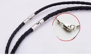 Detail macro view of a black braided leather cord necklace with a silver screw clasp