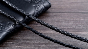 Macro shot showing the detailed texture of black braided leather cord necklace for men