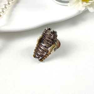 Detail of amber resin hair claw with inlaid gray crystals on elegant pearl tray