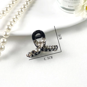 Detail view of mini black rhinestone hair claw clip with dimensions 4.5CM by 3CM