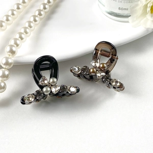 Sparkling rhinestone and pearl mini bow hair claws set in black and amber colors