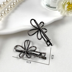 Dettaglio di fermagli per capelli in lega scura con strass in misure 4cm e 6cm