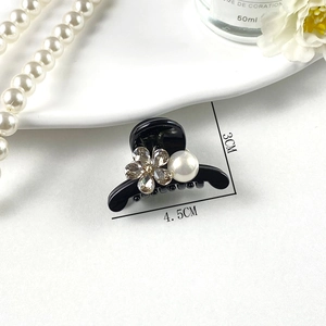 Close-up of small hair claw clip with crystal flower and white pearl, size 4.5cm by 3cm