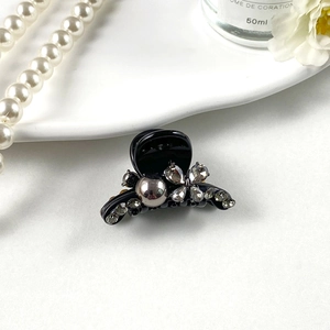 Close-up of sparkling rhinestone hair claw clip with elegant crystal flower detailing