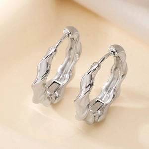Minimalist silver wave earrings with a high-polish liquid metal texture design