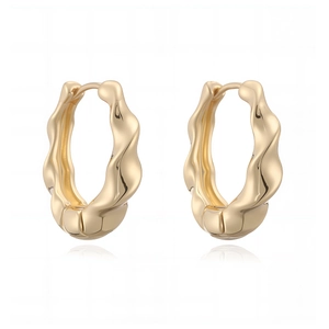 Detailed macro view of gold-plated wavy hoop earrings with a polished metallic finish